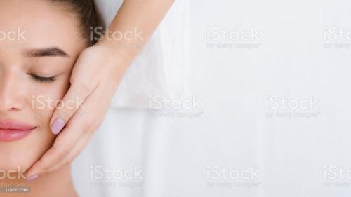 Woman getting professional facial massage, top view, copy space